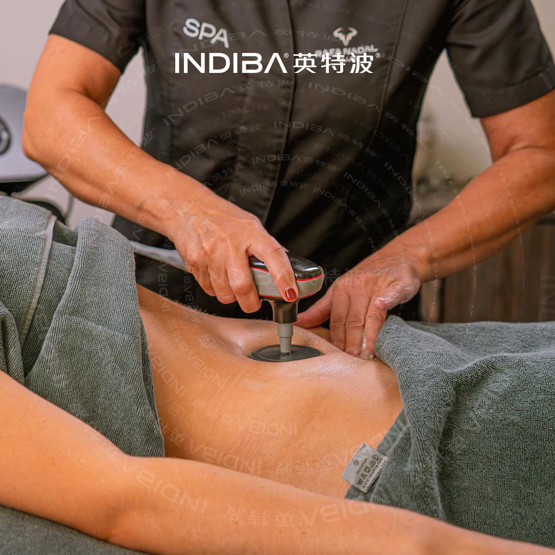 Therapist applying an authentic INDIBA electrode during a body treatment