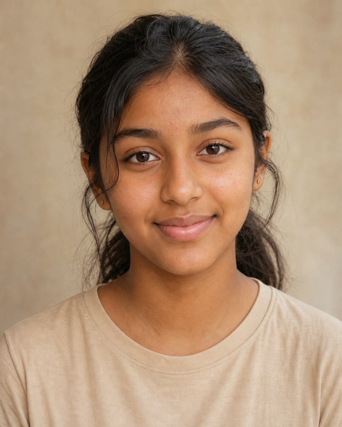 South Asian teenager aged 15 with medium-brown skin and natural texture